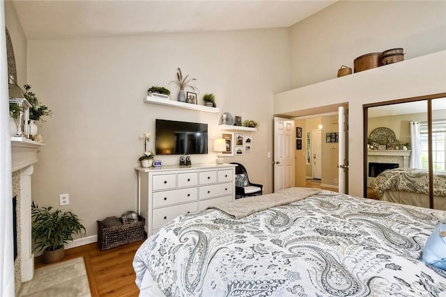 543 Rockport Ct, Encinitas, CA 92024 - bedroom featuring a fireplace, light wood-style floors, baseboards, and high vaulted ceiling