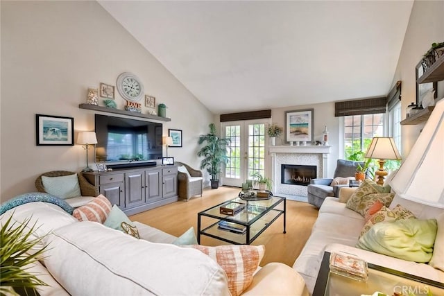 543 Rockport Ct, Encinitas, CA 92024 - living area with light wood-style flooring, a glass covered fireplace, and high vaulted ceiling