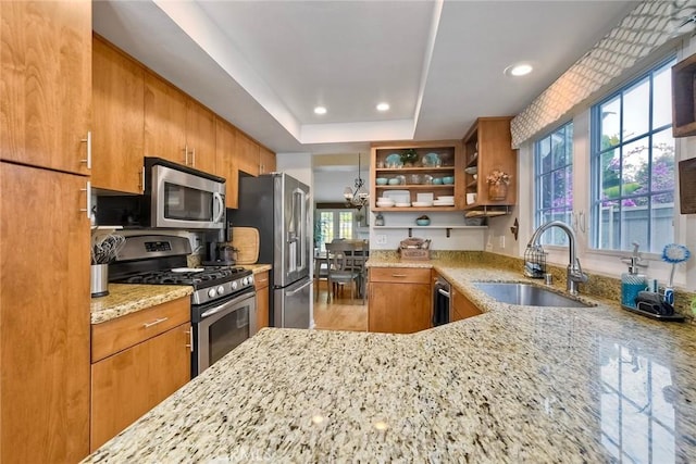 543 Rockport Ct, Encinitas, CA 92024 - kitchen featuring a sink, appliances with stainless steel finishes, light stone countertops, open shelves, and brown cabinetry