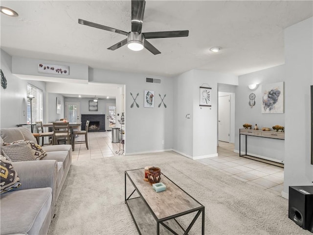 7352 N Adoline Ave, Fresno, CA 93711 - living area with light tile patterned flooring, ceiling fan, light carpet, and a brick fireplace