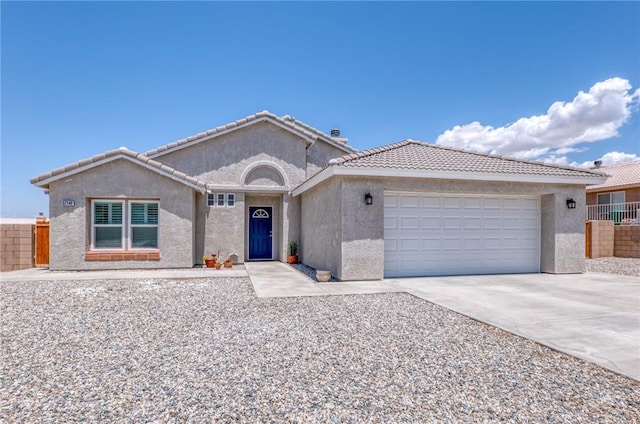57146 Selecta Ave, Yucca Valley, CA 92284 - ranch-style home featuring stucco siding, a garage, driveway, and a tile roof