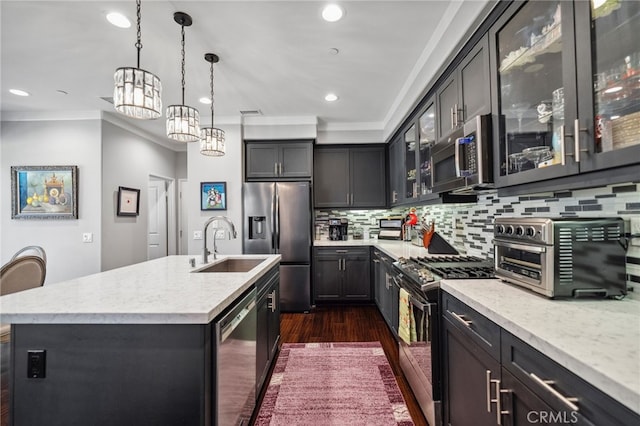 45445 Calle Cirros, Temecula, CA 92592 - kitchen with appliances with stainless steel finishes, dark wood-type flooring, ornamental molding, a center island with sink, and a chandelier