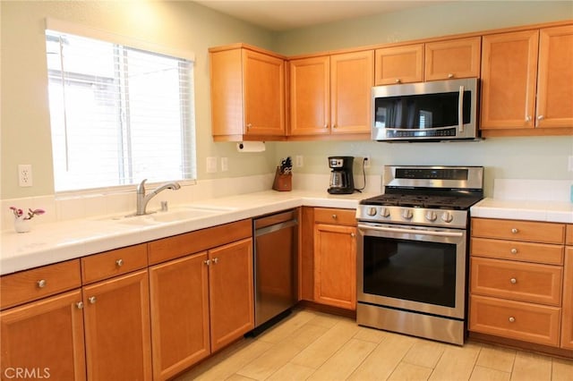 38564 Pallas Ct, Palmdale, CA 93551 - kitchen featuring appliances with stainless steel finishes, a sink, and tile countertops