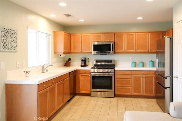 38564 Pallas Ct, Palmdale, CA 93551 - kitchen featuring stainless steel appliances, a sink, light wood-style flooring, and recessed lighting