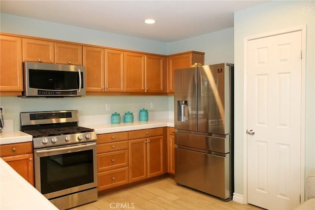 38564 Pallas Ct, Palmdale, CA 93551 - kitchen featuring stainless steel appliances, light wood-style flooring, brown cabinetry, tile countertops, and recessed lighting