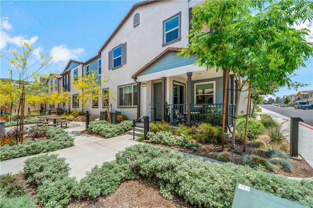 15210 Horizon St Unit 2, Fontana, CA 92336 - back of property featuring a porch, stucco siding, and a residential view