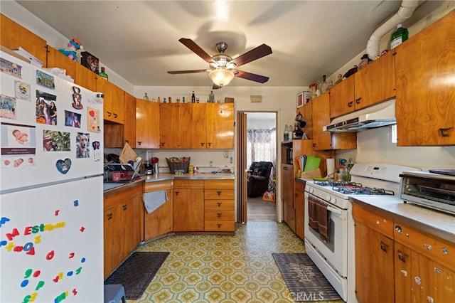 6532 Bonnie Vale Ave, Pico Rivera, CA 90660 - kitchen with white appliances, under cabinet range hood, ceiling fan, and brown cabinetry