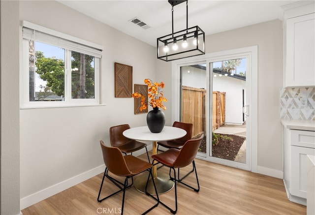 1905 Davis St, Corona, CA 92882 - dining room featuring light wood-style floors, baseboards, and a chandelier