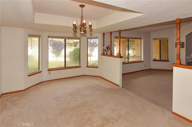 22478 Poppy Rd, Apple Valley, CA 92308 - carpeted empty room with baseboards, plenty of natural light, a chandelier, and a tray ceiling