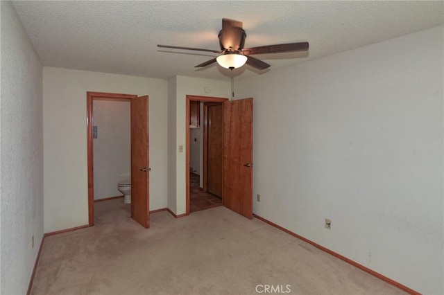 22478 Poppy Rd, Apple Valley, CA 92308 - unfurnished bedroom with light colored carpet, baseboards, ensuite bath, a textured ceiling, and ceiling fan