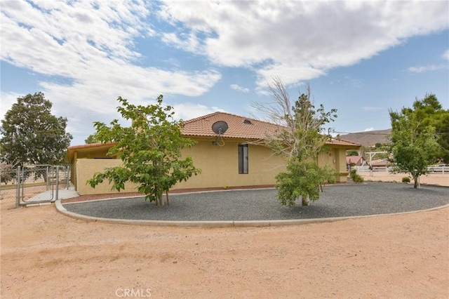 22478 Poppy Rd, Apple Valley, CA 92308 - view of front of home with stucco siding, a tile roof, and a gate