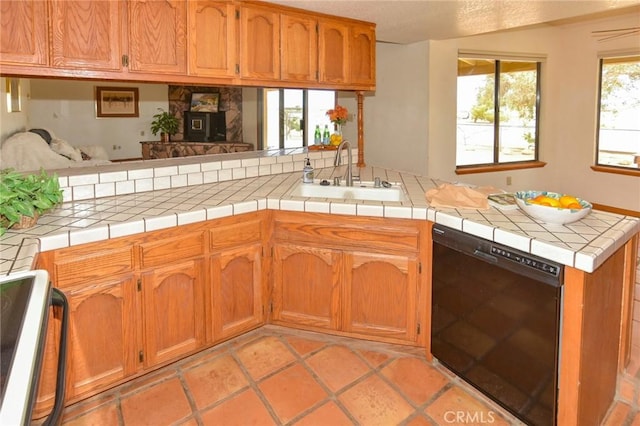 22478 Poppy Rd, Apple Valley, CA 92308 - kitchen with dishwasher, a sink, stove, brown cabinetry, and a peninsula