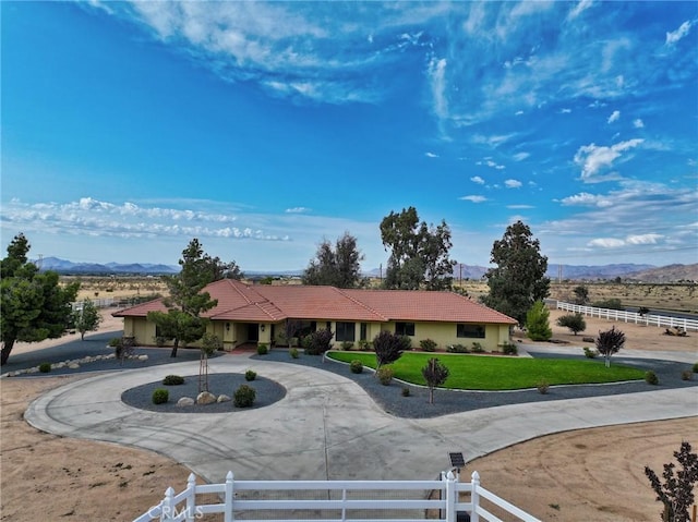 22478 Poppy Rd, Apple Valley, CA 92308 - ranch-style home featuring curved driveway, a mountain view, a tile roof, and stucco siding
