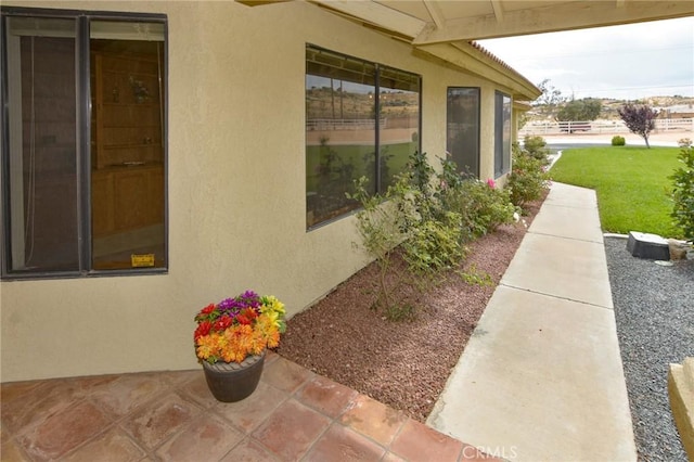 22478 Poppy Rd, Apple Valley, CA 92308 - view of property exterior with stucco siding and a patio