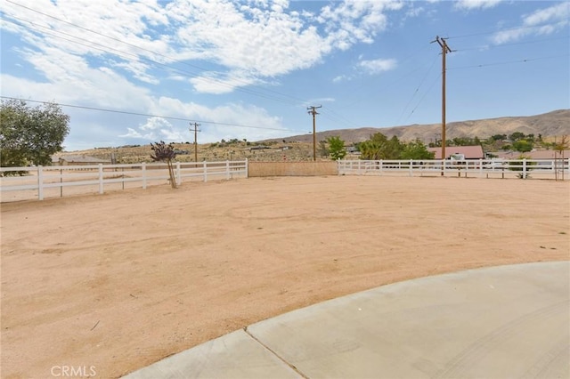 22478 Poppy Rd, Apple Valley, CA 92308 - view of yard featuring an outdoor riding arena, a mountain view, and a view of countryside