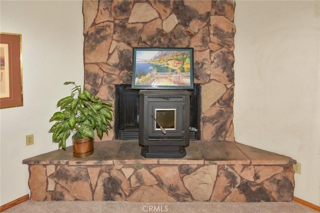 22478 Poppy Rd, Apple Valley, CA 92308 - detailed view of a wood stove, baseboards, and carpet floors