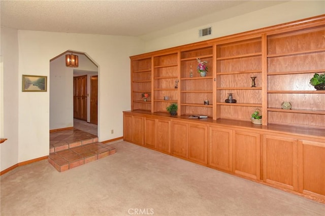22478 Poppy Rd, Apple Valley, CA 92308 - corridor featuring arched walkways, carpet, a textured ceiling, and baseboards