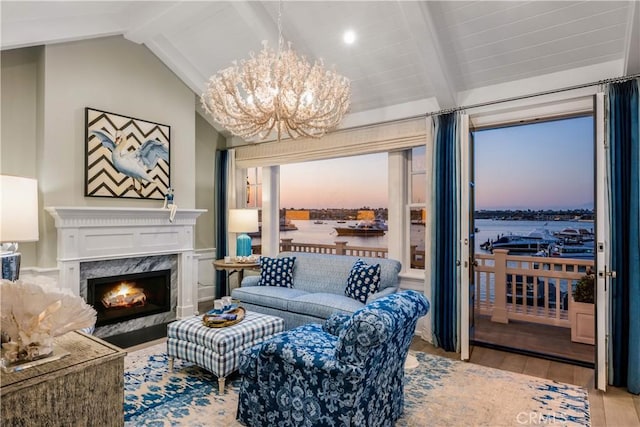 505 W Edgewater Ave, Newport Beach, CA 92661 - living room with wood finished floors, a chandelier, a premium fireplace, and a water view