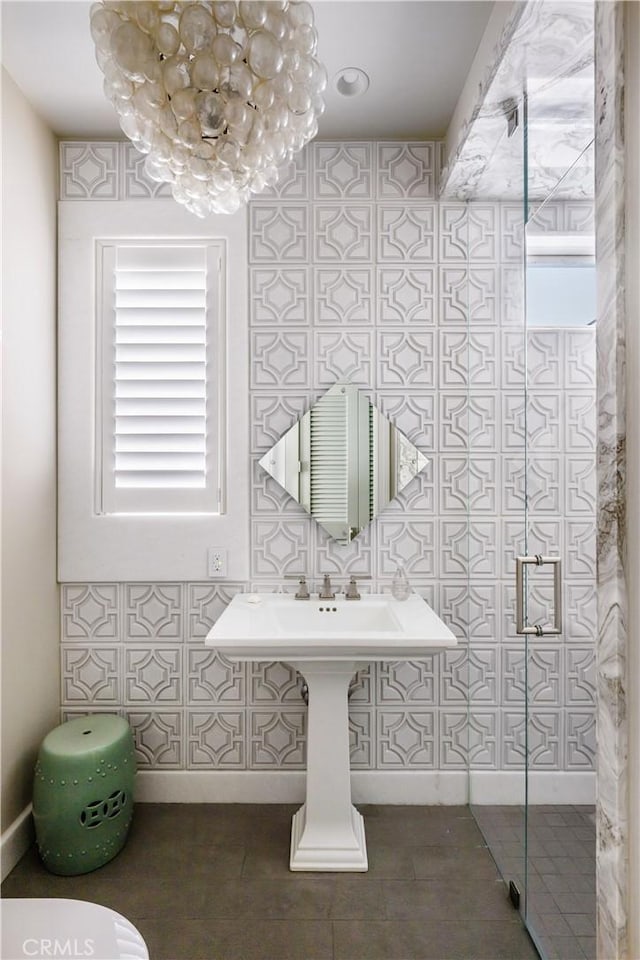 505 W Edgewater Ave, Newport Beach, CA 92661 - bathroom with tile patterned floors, a chandelier, and tile walls