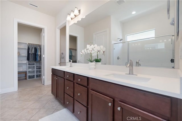 24385 Overlook Dr, Corona, CA 92883 - bathroom featuring double vanity, a spacious closet, a shower stall, and tile patterned flooring