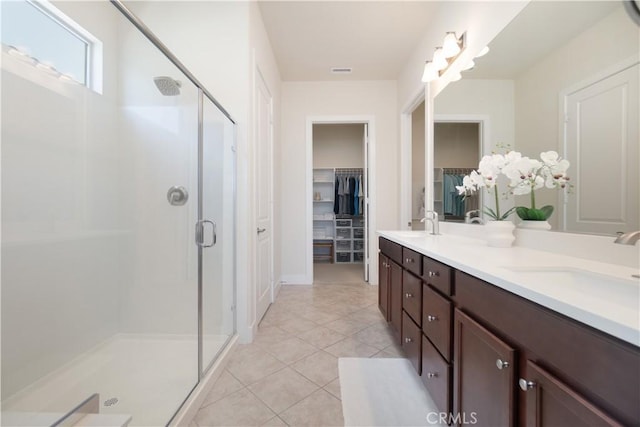 24385 Overlook Dr, Corona, CA 92883 - bathroom featuring a shower stall, a walk in closet, double vanity, and tile patterned floors