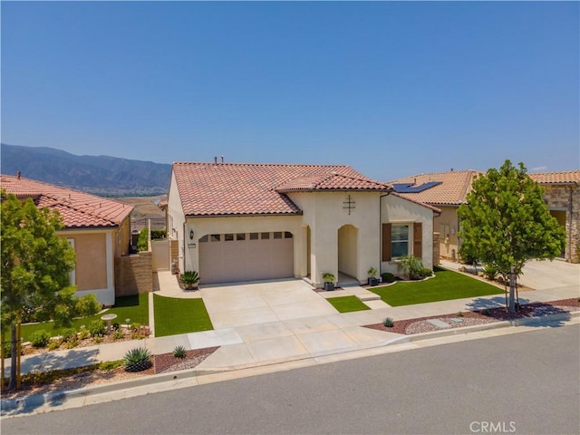 24385 Overlook Dr, Corona, CA 92883 - mediterranean / spanish home featuring a garage, stucco siding, a tiled roof, concrete driveway, and a front yard