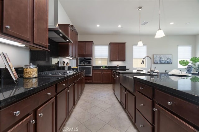 24385 Overlook Dr, Corona, CA 92883 - kitchen with wall chimney range hood, stainless steel appliances, hanging light fixtures, light tile patterned flooring, and dark stone countertops