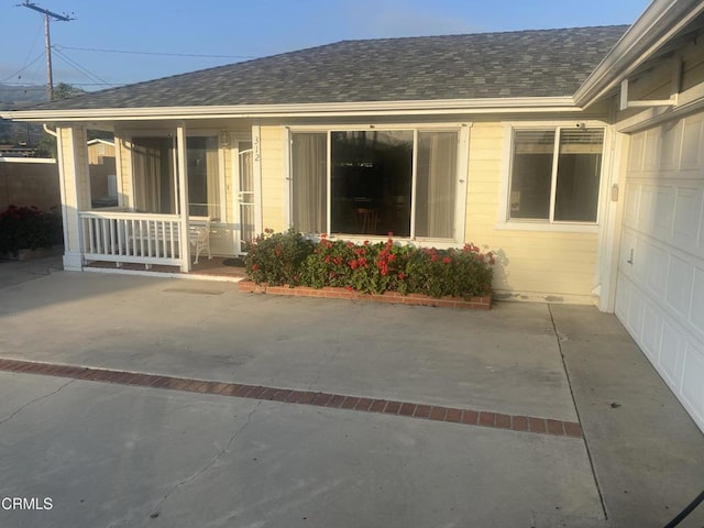 312 Rhodes Ct, Fillmore, CA 93015 - view of exterior entry featuring roof with shingles and a porch