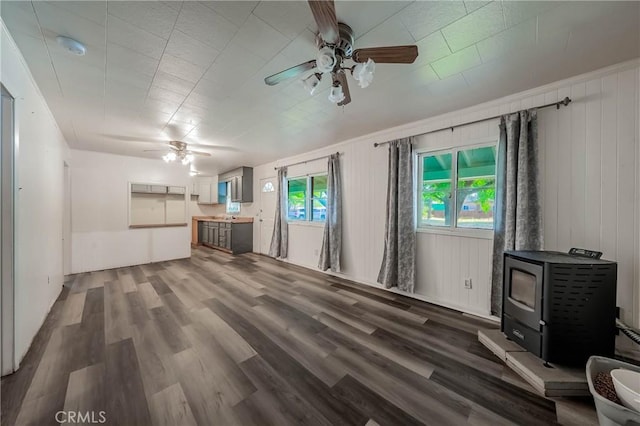 14410 Walnut Ave, Clearlake, CA 95422 - unfurnished living room with a ceiling fan, a wood stove, and dark wood finished floors
