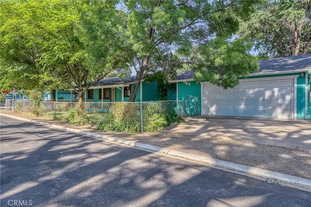 14410 Walnut Ave, Clearlake, CA 95422 - view of front of house with a fenced front yard, a garage, and a shingled roof