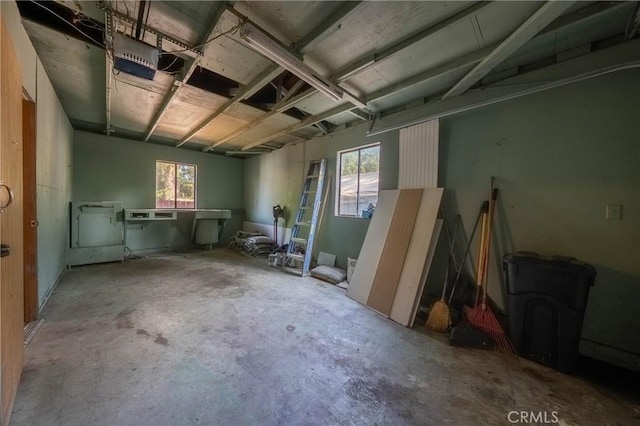 14410 Walnut Ave, Clearlake, CA 95422 - misc room with a garage, unfinished concrete flooring, and plenty of natural light