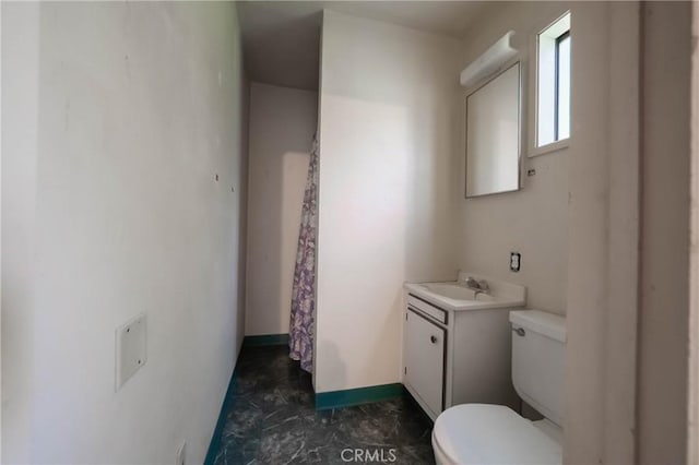14410 Walnut Ave, Clearlake, CA 95422 - full bath featuring toilet, vanity, baseboards, and a shower with shower curtain
