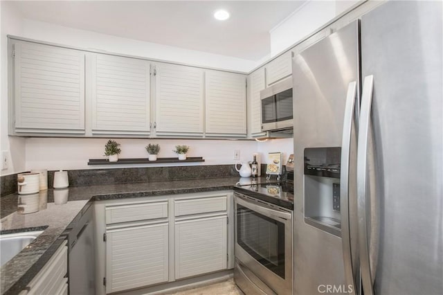 25712 Le Parc Unit 40, Lake Forest, CA 92630 - kitchen featuring appliances with stainless steel finishes, dark stone countertops, and recessed lighting