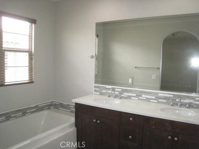 908 Grove Ct, Claremont, CA 91711 - full bath featuring double vanity, a bath, healthy amount of natural light, and decorative backsplash