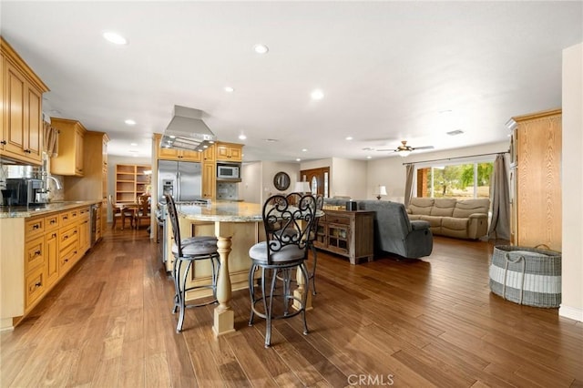 35122 Red Rover Mine Rd, Acton, CA 93510 - kitchen featuring open floor plan, stainless steel refrigerator with ice dispenser, a center island, a kitchen breakfast bar, and wood finished floors
