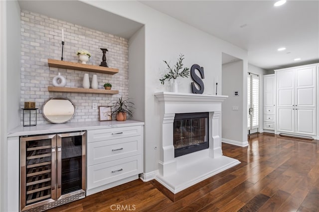 12 John, Ladera Ranch, CA 92694 - bar area with wine cooler, dark wood-style flooring, a glass covered fireplace, recessed lighting, and baseboards