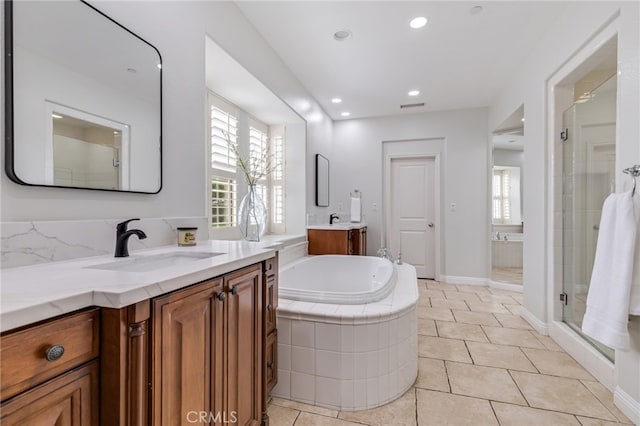 12 John, Ladera Ranch, CA 92694 - full bath featuring two vanities, a stall shower, a garden tub, tile patterned flooring, and recessed lighting