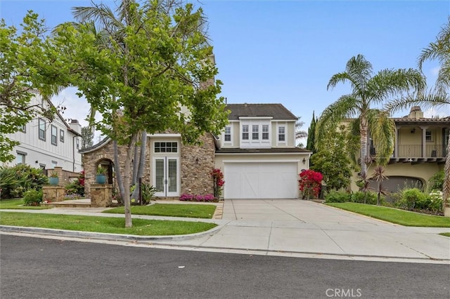 12 John, Ladera Ranch, CA 92694 - view of front of property featuring stone siding, concrete driveway, a garage, and stucco siding