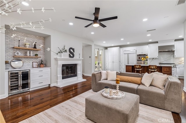 12 John, Ladera Ranch, CA 92694 - living room with beverage cooler, wood finished floors, ceiling fan, a glass covered fireplace, and recessed lighting