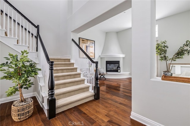 12 John, Ladera Ranch, CA 92694 - stairs with wood finished floors, a large fireplace, and baseboards