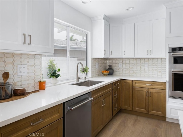 4918 Delacroix Rd, Rancho Palos Verdes, CA 90275 - kitchen featuring appliances with stainless steel finishes, light wood-style flooring, white cabinets, decorative backsplash, and recessed lighting