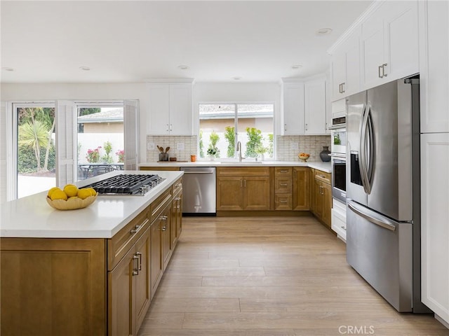 4918 Delacroix Rd, Rancho Palos Verdes, CA 90275 - kitchen with appliances with stainless steel finishes, light countertops, tasteful backsplash, white cabinetry, and recessed lighting
