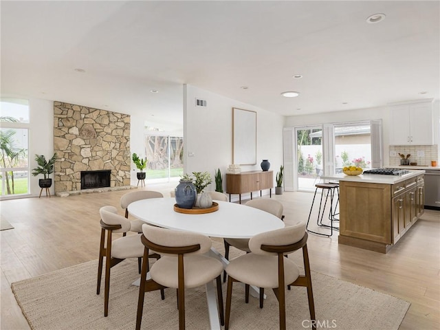 4918 Delacroix Rd, Rancho Palos Verdes, CA 90275 - dining area with light wood-type flooring, a stone fireplace, and recessed lighting