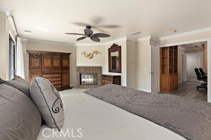 5131 Via Del Valle St, La Verne, CA 91750 - bedroom featuring crown molding, a brick fireplace, and ceiling fan