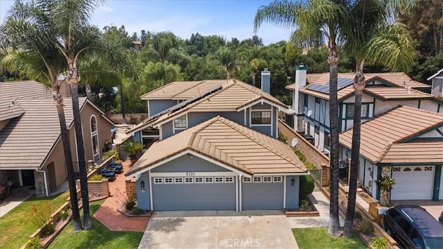 5131 Via Del Valle St, La Verne, CA 91750 - view of front of house featuring a tile roof, a garage, driveway, and a chimney