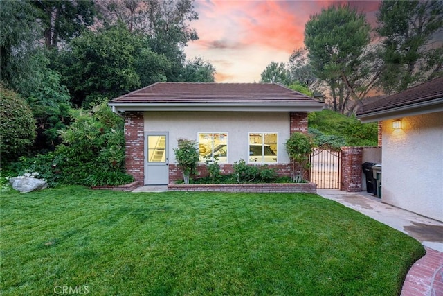 25578 Via Paladar, Valencia, CA 91355 - view of front of home with a front yard, brick siding, a gate, and a tile roof