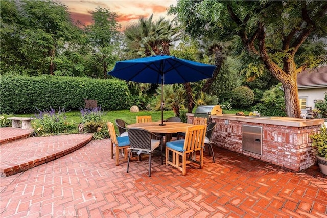 25578 Via Paladar, Valencia, CA 91355 - patio terrace at dusk with area for grilling, outdoor dining space, and a patio area