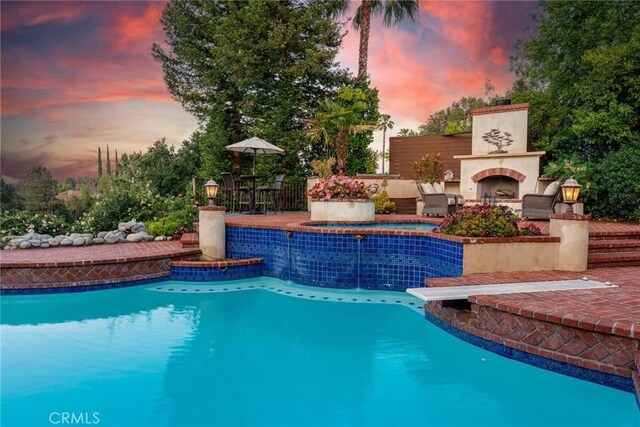 25578 Via Paladar, Valencia, CA 91355 - outdoor pool featuring an outdoor fireplace, a patio area, and an outdoor hot tub