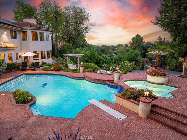 25578 Via Paladar, Valencia, CA 91355 - pool at dusk with an in-ground hot tub, an outdoor pool, and a patio area