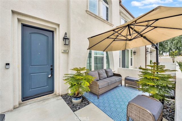 7021 Passons Blvd, Pico Rivera, CA 90660 - view of exterior entry featuring stucco siding, an outdoor living space, and a patio